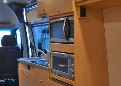 kitchen area viewed from bed of Sprinter Van conversion