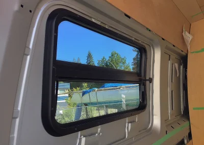 installed window in Mercedes Sprinter van conversion