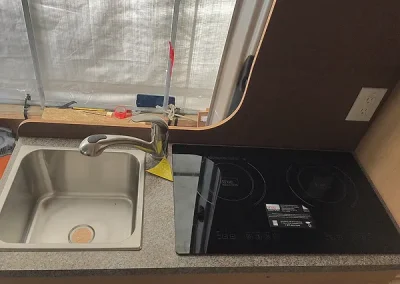 sink and cooktop in Sprinter Van conversion
