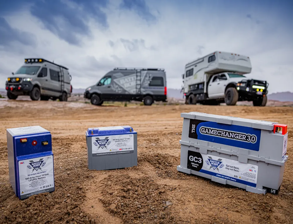 3 off road van conversions in the background behind Battleborn batteries